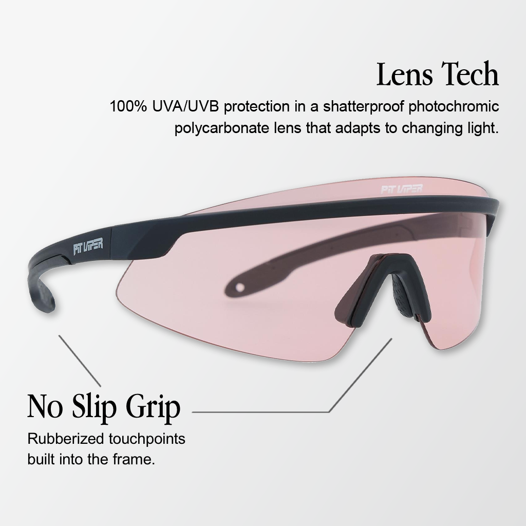 Infographic for Pit Viper Skysurfer photochromic sunglasses showing a side/angled view of a narrow matte black single-shield frame with a light pink photochromic lens and a 'PIT VIPER' logo on the temple with 2 callouts: 'Lens Tech - 100% UVA/UVB protection in a shatterproof photochromic polycarbonate lens that adapts to changing light.', 'No Slip Grip - Rubberized touchpoints built into the frame.'