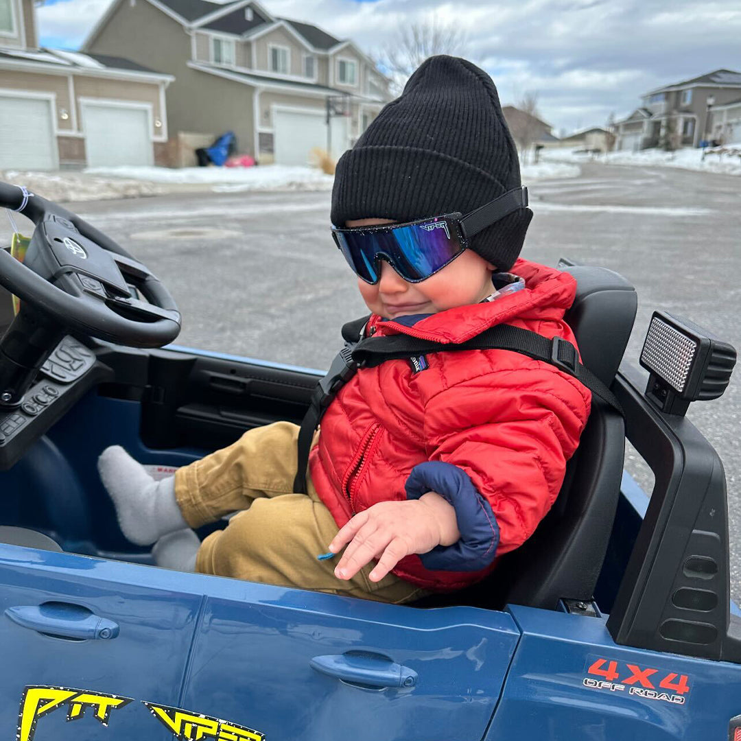 Baby driving a kids car in The Midnight Baby Vipes from Pit Viper Sunglasses