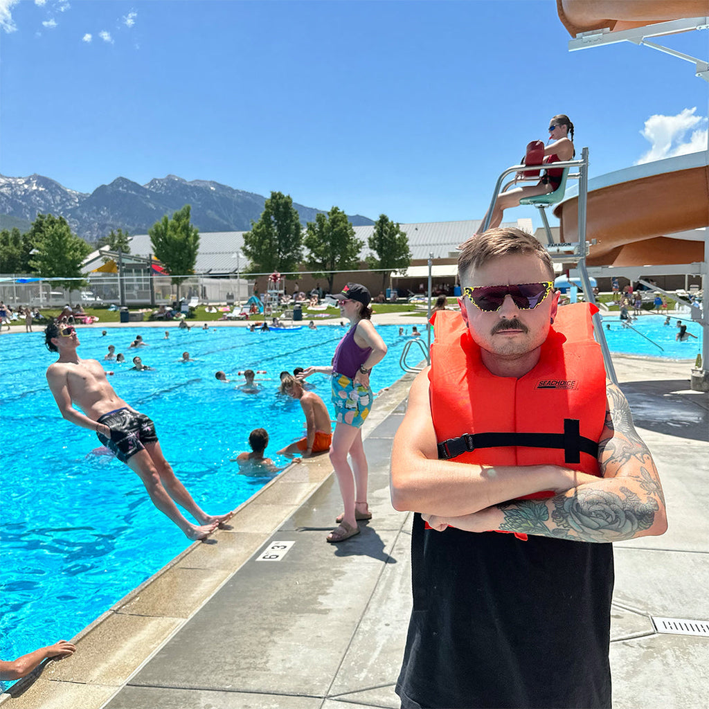 Man wearing a life jacket and The Carnivore Showroom from Pit Viper Sunglasses