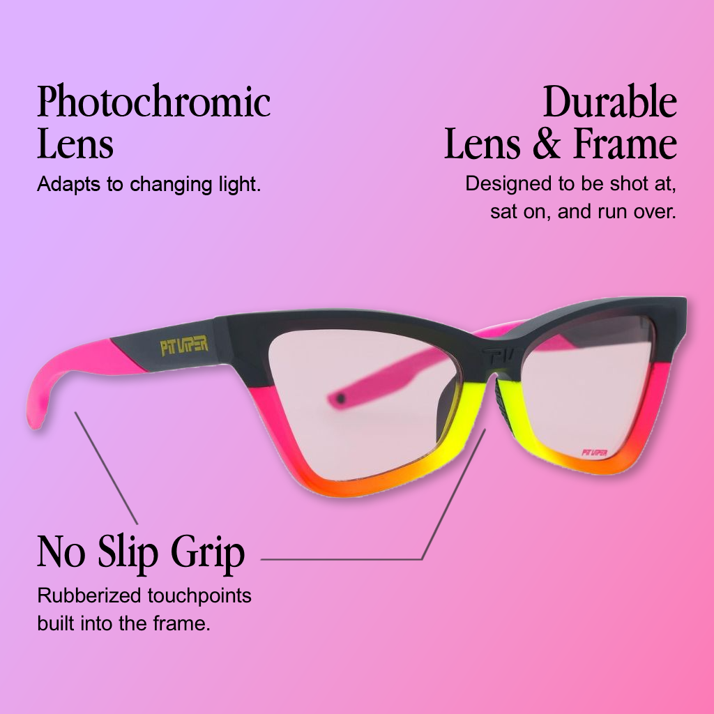 Infographic for Pit Viper Clawdia cat-eye sunglasses showing a black upper frame fading into a pink-orange-yellow gradient at the lower rim, light photochromic lenses, and gold 'PIT VIPER' branding on the temple arm and pink text on the lower frame, set against a purple-to-pink gradient background, with 3 callouts: 'Photochromic Lens - Adapts to changing light.', 'Durable Lens & Frame - Designed to be shot at, sat on, and run over.', 'No Slip Grip - Rubberized touchpoints built into the frame.'