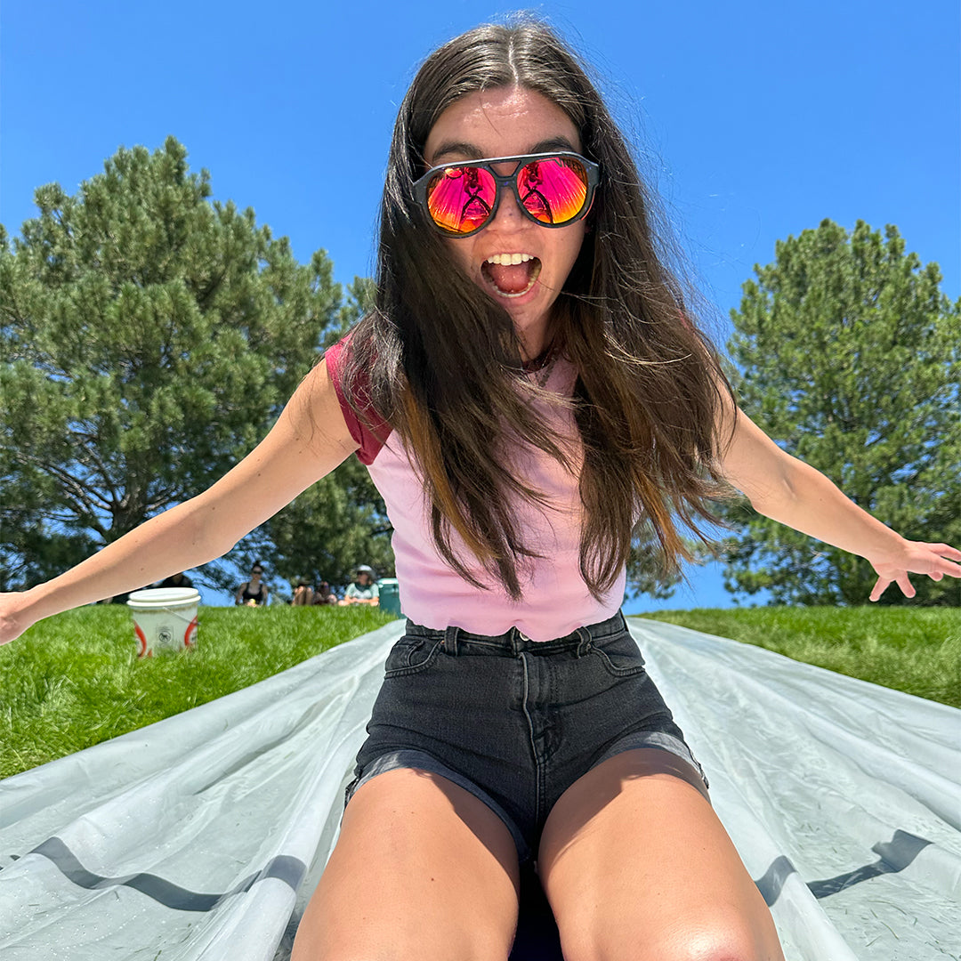 Woman on a slip and slide wearing Pit Viper Sunglasses
