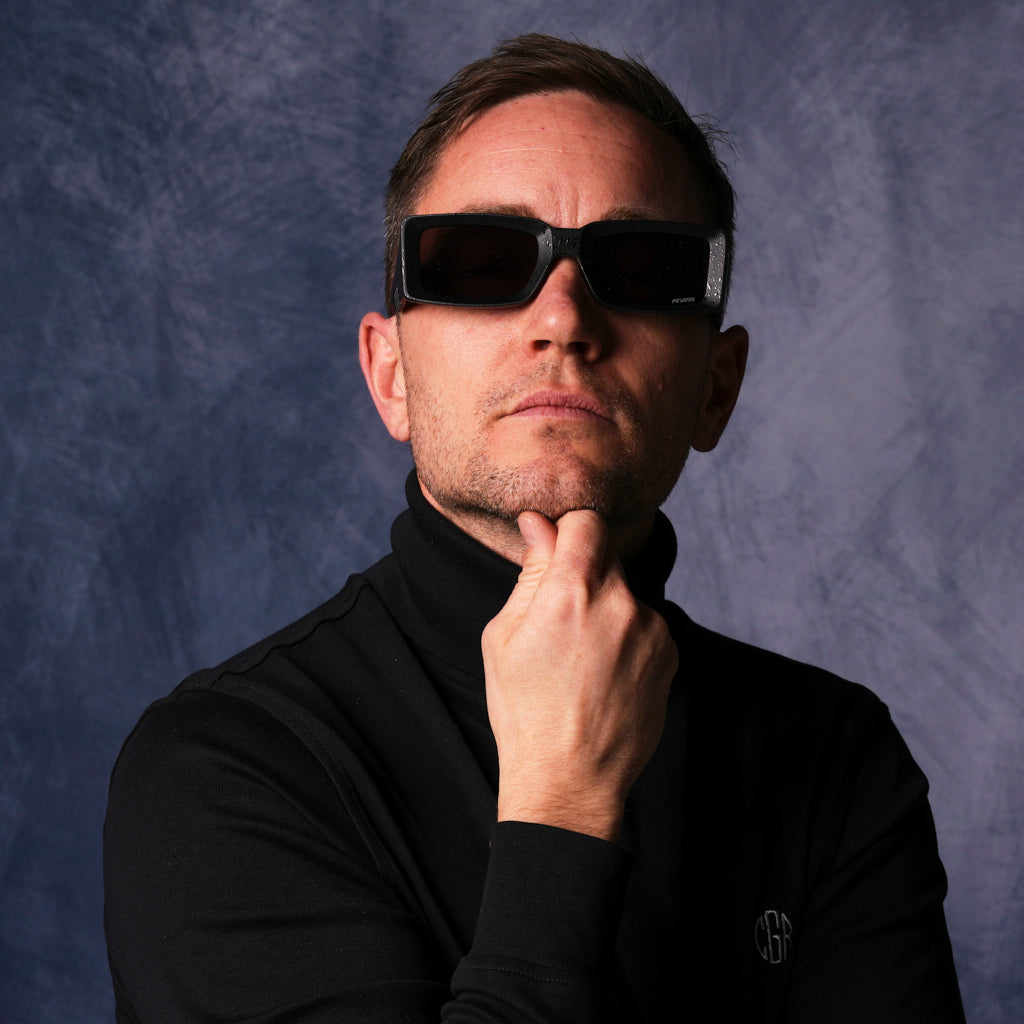 very important businessman wearing a turtleneck and square frame sunglasses
