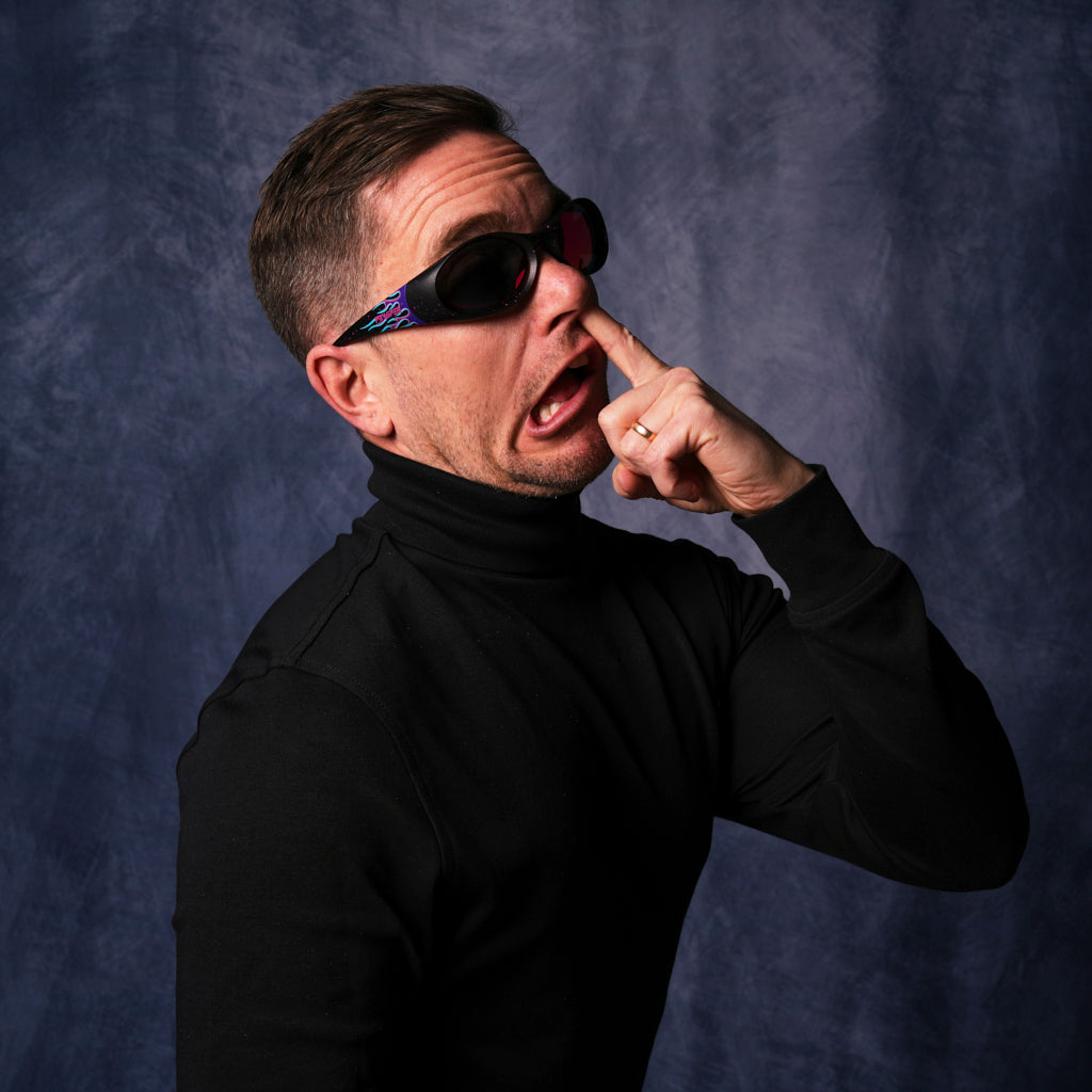 very important businessman picking his nose wearing sunglasses with purple frames on them