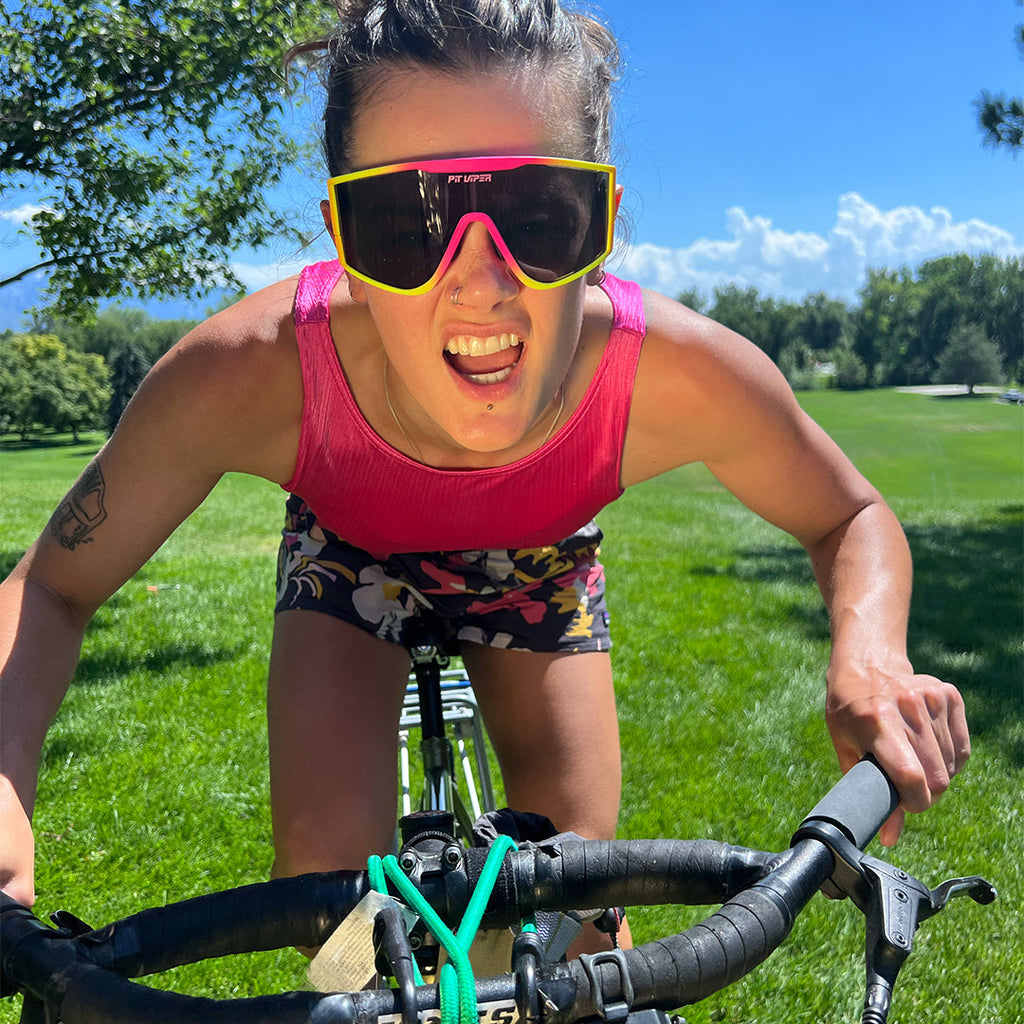 Woman on a bike wearing the Italo Try-Hard from Pit Viper Sunglasses