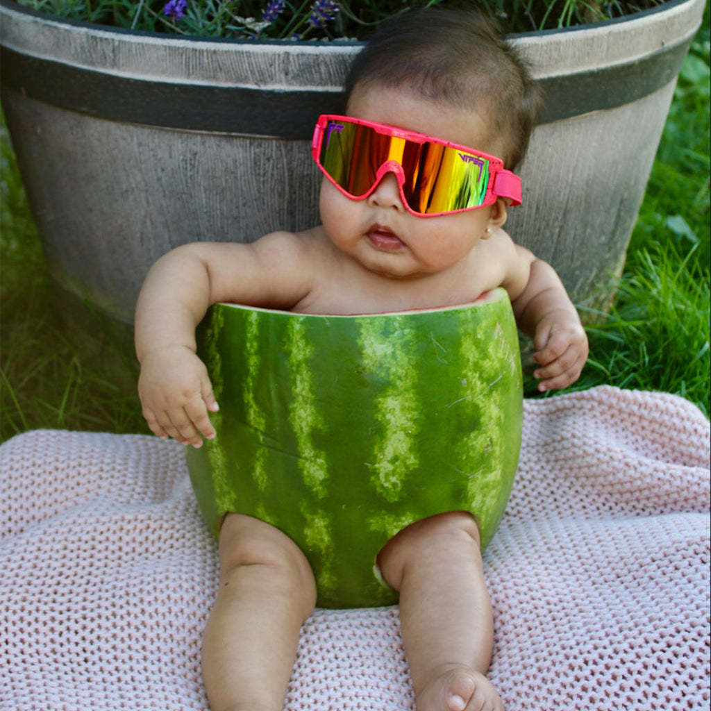 Baby in a watermelon wearing The Radical Baby Vipes from Pit Viper Sunglasses