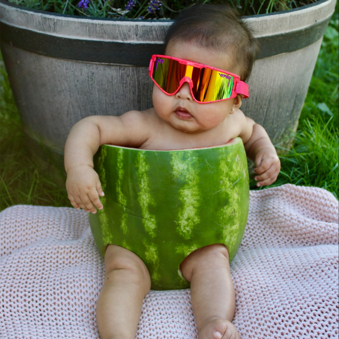 Baby in a watermelon wearing The Radical Baby Vipes from Pit Viper Sunglasses