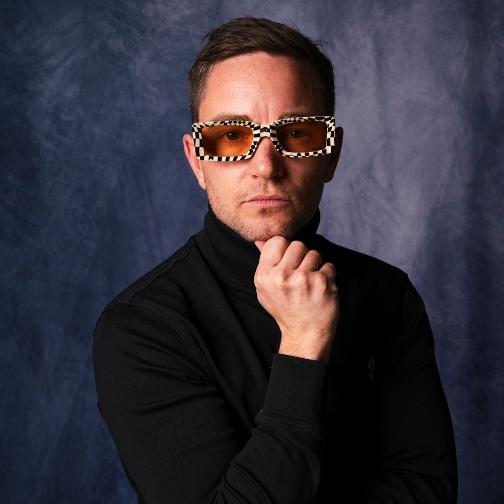 very important businessman wearing a turtleneck and square frame sunglasses