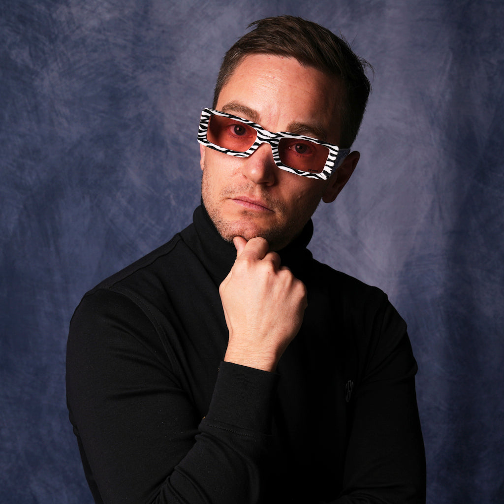 very important businessman wearing a turtleneck and square frame sunglasses