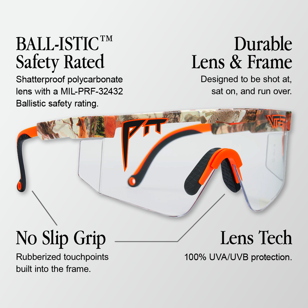 Infographic for Pit Viper Original Ballistic sunglasses with 4 callouts: 'BALL-ISTIC™ Safety Rated - Shatterproof polycarbonate lens with a MIL-PRF-32432 Ballistic safety rating.', 'Durable Lens & Frame - Designed to be shot at, sat on, and run over.', 'No Slip Grip - Rubberized touchpoints built into the frame.', 'Lens Tech - 100% UVA/UVB protection.'