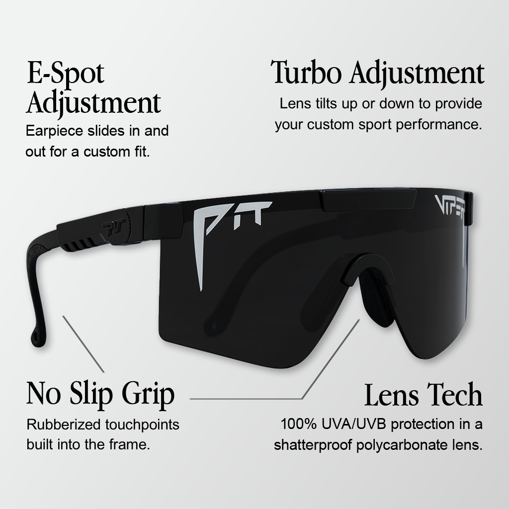 Infographic for Pit Viper Original sunglasses showing an angled side view of a black wraparound frame with a bold 'PIT' outline logo and 'VIPER' logo on the dark mirrored lens, with 4 callouts: 'E-Spot Adjustment - Earpiece slides in and out for a custom fit.', 'Turbo Adjustment - Lens tilts up or down to provide your custom sport performance.', 'No Slip Grip - Rubberized touchpoints built into the frame.', 'Lens Tech - 100% UVA/UVB protection in a shatterproof polycarbonate lens.'