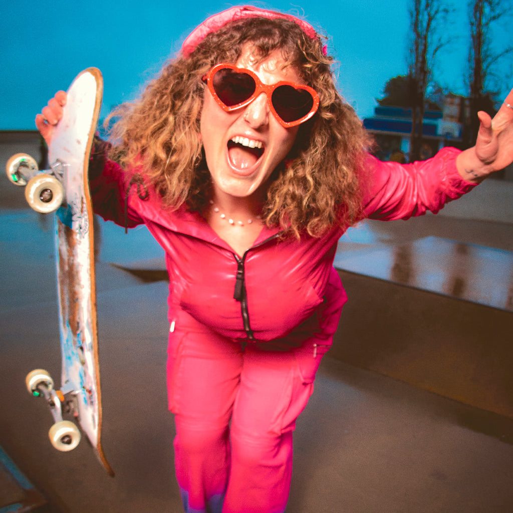 Woman holding a skateboard in The Responder Admirer from Pit Viper Sunglasses